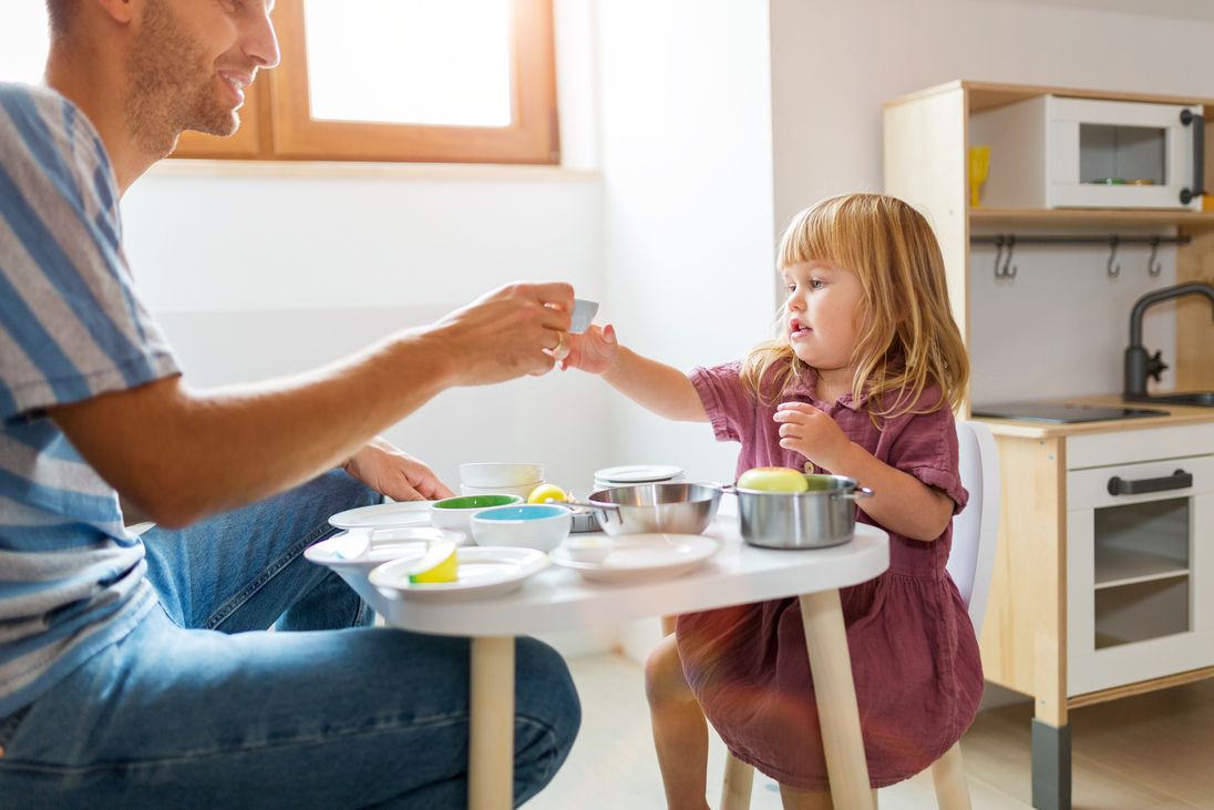 Father and daugther playing in little kitchen (Edyta Pawlowska / photocase.de)